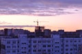 Morning city panorama with a view of residential apartment buildings, a tower crane and a high-rise building under construction Royalty Free Stock Photo