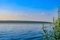 Morning panorama view over river from fishing place to opposite bank, reflection of sky in the water level Royalty Free Stock Photo