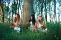 Pagan Girls in the forest by the tree Royalty Free Stock Photo