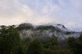 Morning picture of the foggy mountains with clouds in Norway. Royalty Free Stock Photo