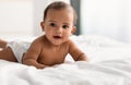 Cute adorable little African American kid lying on bed Royalty Free Stock Photo