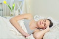 Morning portrait of sleeping young beautiful woman lying at home in bedroom on bed Royalty Free Stock Photo