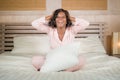 Morning portrait of young beautiful and happy African American woman in pajamas relaxed and cheerful on bed awake in the morning Royalty Free Stock Photo