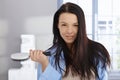 Morning portrait of young woman with hairbrush