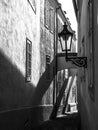 Morning Prague scene. Sunlit and long shadows on the wall with gas street lamp, Thunovska Street, Lesser Town, Prague