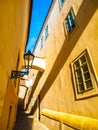 Morning Prague scene. Sunlit and long shadows on the wall with gas street lamp, Thunovska Street, Lesser Town, Prague