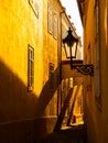 Morning Prague scene. Sunlit and long shadows on the wall with gas street lamp, Thunovska Street, Lesser Town, Prague