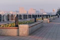 Morning red light of the sun on the river embankment with flower beds. Promenade of the city of Blagoveshchensk, Russia Royalty Free Stock Photo