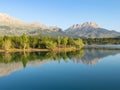 Morning reflections, mystical nature and fascinating mountains in the dam pond