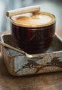 Morning refreshing with Espresso with milk foam served with Crispy Stick Candy on a Transparent Glass