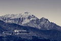 Morning rises above snowy mountain range.