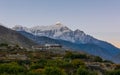 Morning rises above snowy mountain range.