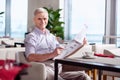 Cheerful mature man spending time with newspaper Royalty Free Stock Photo