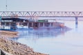 Morning on the river berth of the shipyard. Fog over the water. New boats near the slip. Coal warehouse. Old automobile Royalty Free Stock Photo