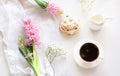 Morning romance breakfast, cup of coffee, milk jug and cake with decor of pink hyacinth. Spring. Top view. Royalty Free Stock Photo