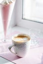 Morning routine at home - White cup of coffee on the table in sunlight. minimal concept on windowsill