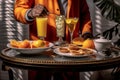 A morning routine scene with a person holding a tray of breakfast items, featuring a prominently placed glass of orange juice,