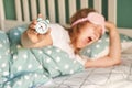 Morning routine. Young pretty woman wake up at home. Bed time. Snooze alarm Royalty Free Stock Photo