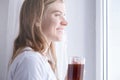 Woman Standing By Bedroom Window And drinking fresh coffee Royalty Free Stock Photo