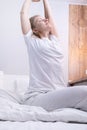 Woman stretching in bed after wake up Royalty Free Stock Photo
