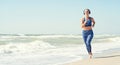 Morning run along the coast.Woman doing exercises on the beach, meet the sunrise.Fitness, sport, yoga and healthy lifestyle concep Royalty Free Stock Photo