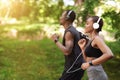 Morning Run Concept. Sporty Black Man And Woman Jogging Outdoor In Park Royalty Free Stock Photo