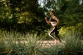 Morning run, woman on training in summer park Royalty Free Stock Photo