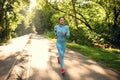 Morning run, woman on training in summer park Royalty Free Stock Photo