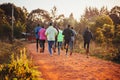 Morning running training in Kenya. A group of endurance runners run on red soil at sunrise. Morning running motivation for
