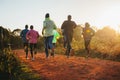 Morning running training. in Kenya. Marathon runners on red soil train in the light of the rising sun. Motivation to move.