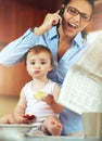 The morning rush. a busy young mother at home with her baby. Royalty Free Stock Photo