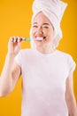 Morning rutine teeth brushing lovely woman on yellow background.