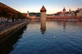 Morning scenery of Chapel Bridge  Kapellbrucke  over Reuss River, in Old Town Lucern, Switzerland, with Wasserturm Water Tower Royalty Free Stock Photo