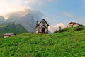 Morning scenery of a lovely church at the foothills of rugged mountain peaks Cimon della Pala