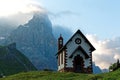 Morning scenery of a lovely church at the foothills of rugged mountain peaks