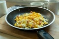 Morning scrambled eggs with bacon in a pan