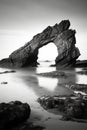 Morning Serenity: Natural Rock Arch Against Calm Sea and Horizon