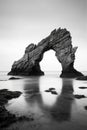 Morning Serenity: Natural Rock Arch Against Calm Sea and Horizon