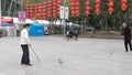 Shenzhen, China: elderly people play top as a fitness exercise in the morning sports square