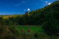 Morning shadow natural lighting highland rural region scenic view in spring day time with idyllic green grass meadow and stack of Royalty Free Stock Photo