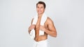 Young man standing with towel at white studio Royalty Free Stock Photo