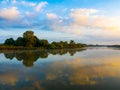 Morning sky with clouds over the river. Beautiful sunrise and reflecting clouds in a river. Royalty Free Stock Photo