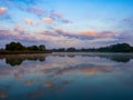 Beautiful sunrise and reflecting clouds in a river. Royalty Free Stock Photo