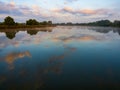 Morning sky with clouds over the river. Beautiful sunrise and reflecting clouds in a river. Royalty Free Stock Photo