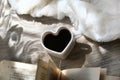 Morning still life, coffee in bed. White cup in shape heart and fluffy plaid. Shadow and sunlight. At home. Rustic style, Lazy Royalty Free Stock Photo