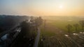Sunrise Over Winding Road and Canal in a Misty Countryside Setting Royalty Free Stock Photo