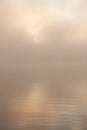 Morning sun through fog at lake Royalty Free Stock Photo