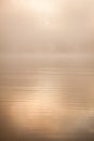 Morning sun through fog at lake Royalty Free Stock Photo