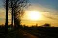 Morning sun with greenhouses and arriving car in the countryside. Deserted and evening sun on the bike path.