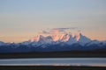 Morning Sun raising beside Nam Lake under the Snow Mountain Royalty Free Stock Photo